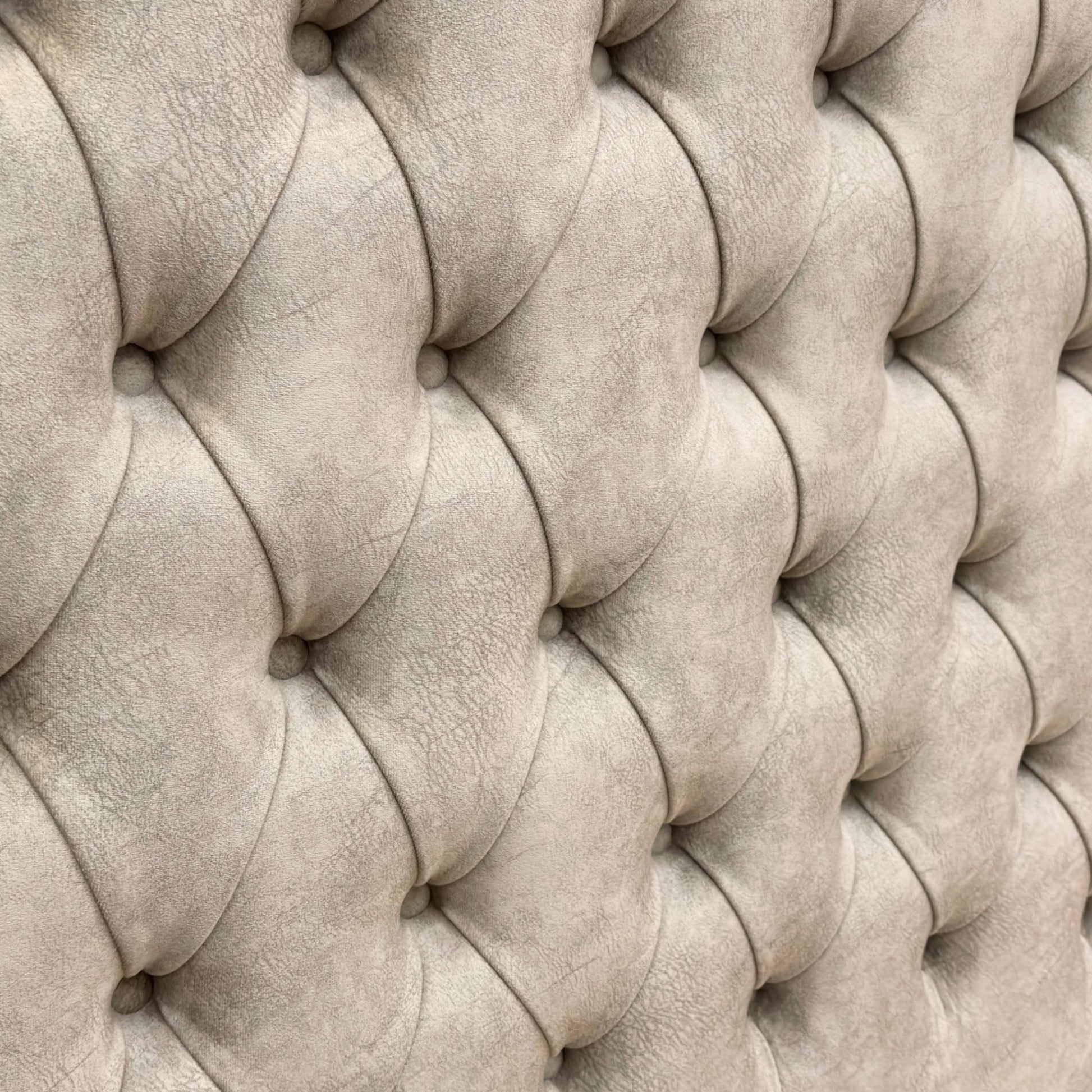 Close-up detail of the soft Dapple Oyster velvet upholstery and button-tufted stitching on the tall headboard.