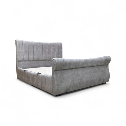 Gray upholstered bed on a white background