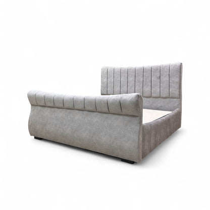 Gray upholstered bed with tufted headboard on a white background