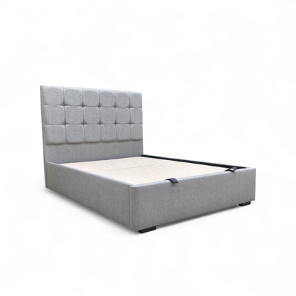 Side angle view of the Capricorn king bed, showcasing the profile of the floor-standing headboard and the clean lines of the upholstered base.