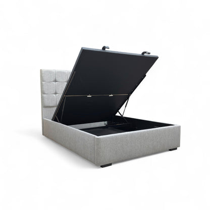 Demonstration of the end-lift ottoman storage mechanism, showing the bed base lifting easily at the foot of the bed to reveal spacious storage underneath.