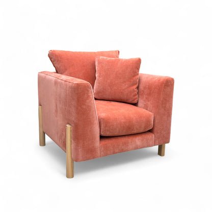 Orange armchair with cushions on a white background