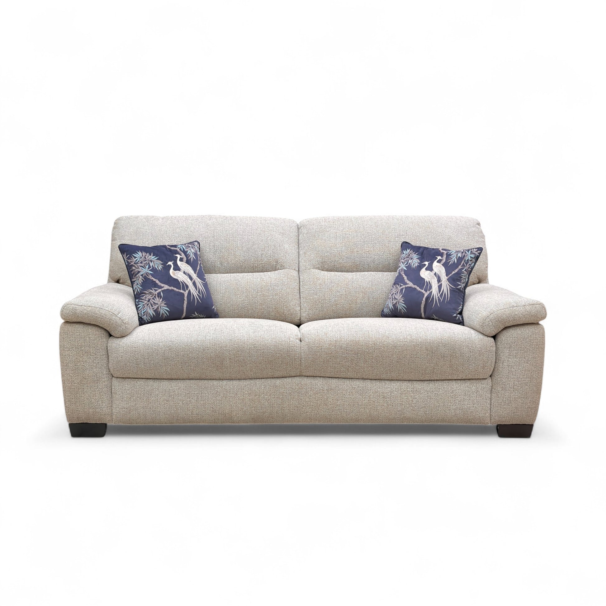 Beige sofa with blue pillows on a white background