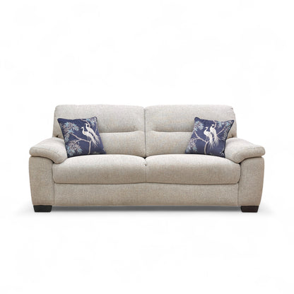 Beige sofa with blue pillows on a white background