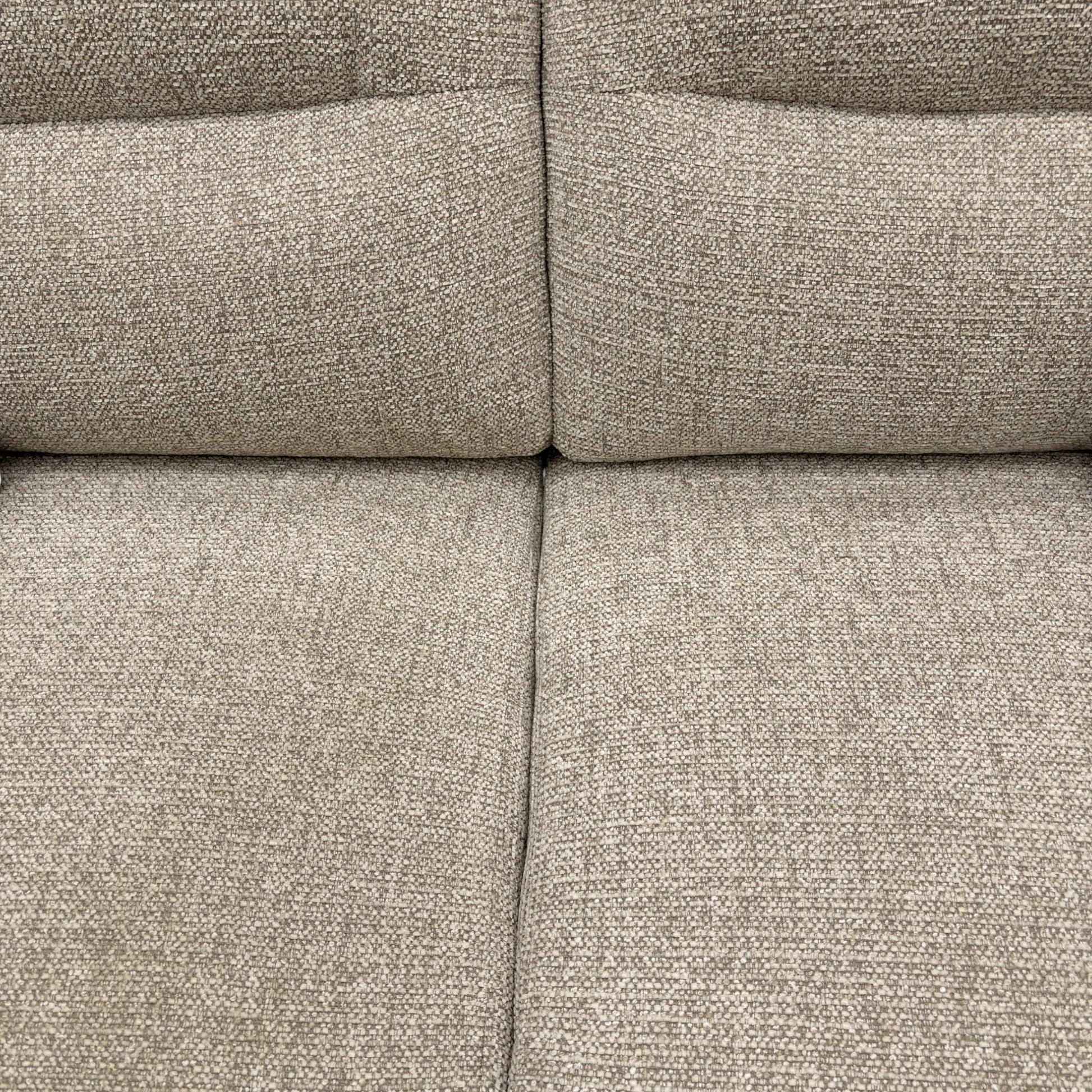 Close-up of a textured beige fabric sofa surface