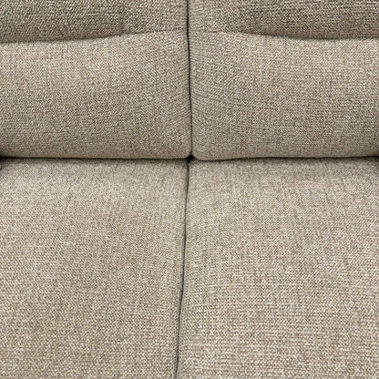 Close-up of a textured beige fabric sofa surface