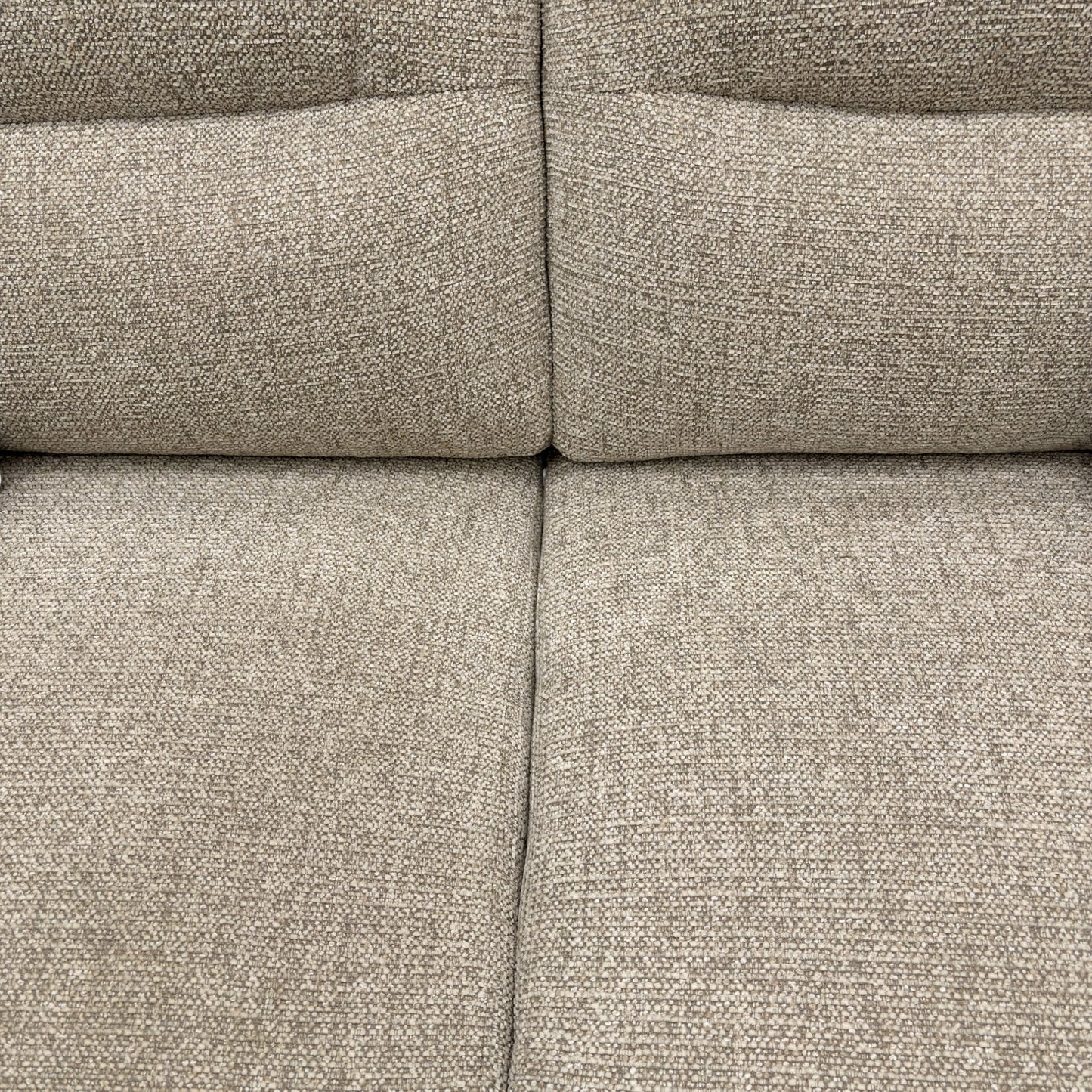 Close-up of a textured beige fabric sofa surface