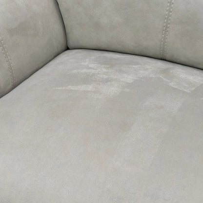Extreme close-up detail of the bluish-grey suede fabric upholstery, showing the soft texture and subtle colour variation.