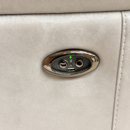 Close-up of the power recliner control buttons embedded on the inner side of the armrest.