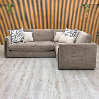 Lifestyle shot of the ‘Barney’ corner sofa in a contemporary living room setting, emphasizing its sophisticated silhouette.