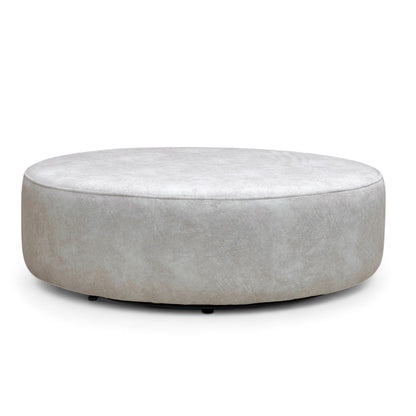 Angled, overhead view of the Dapple Cream velvet footstool, highlighting its generous size and round shape suitable for use as a coffee table