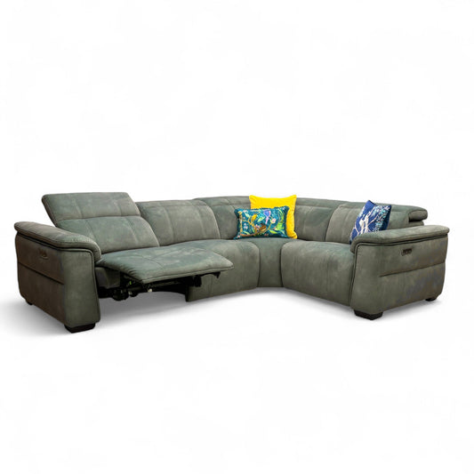 Angled view of the Moss Green velvet corner sofa, highlighting the texture of the fabric and the contemporary shape with the adjustable headrests in the low position