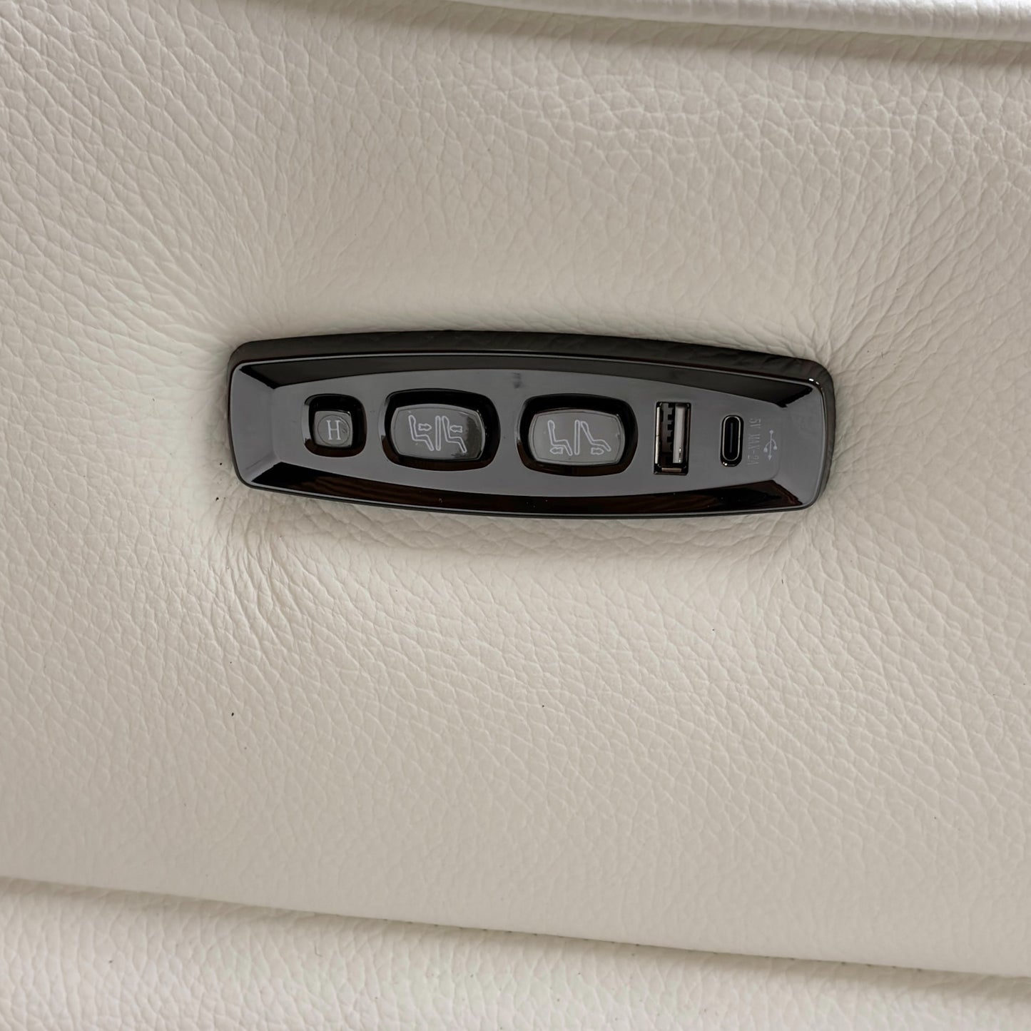 Close-up of the power headrest mechanism in the upright position, demonstrating the high-back support