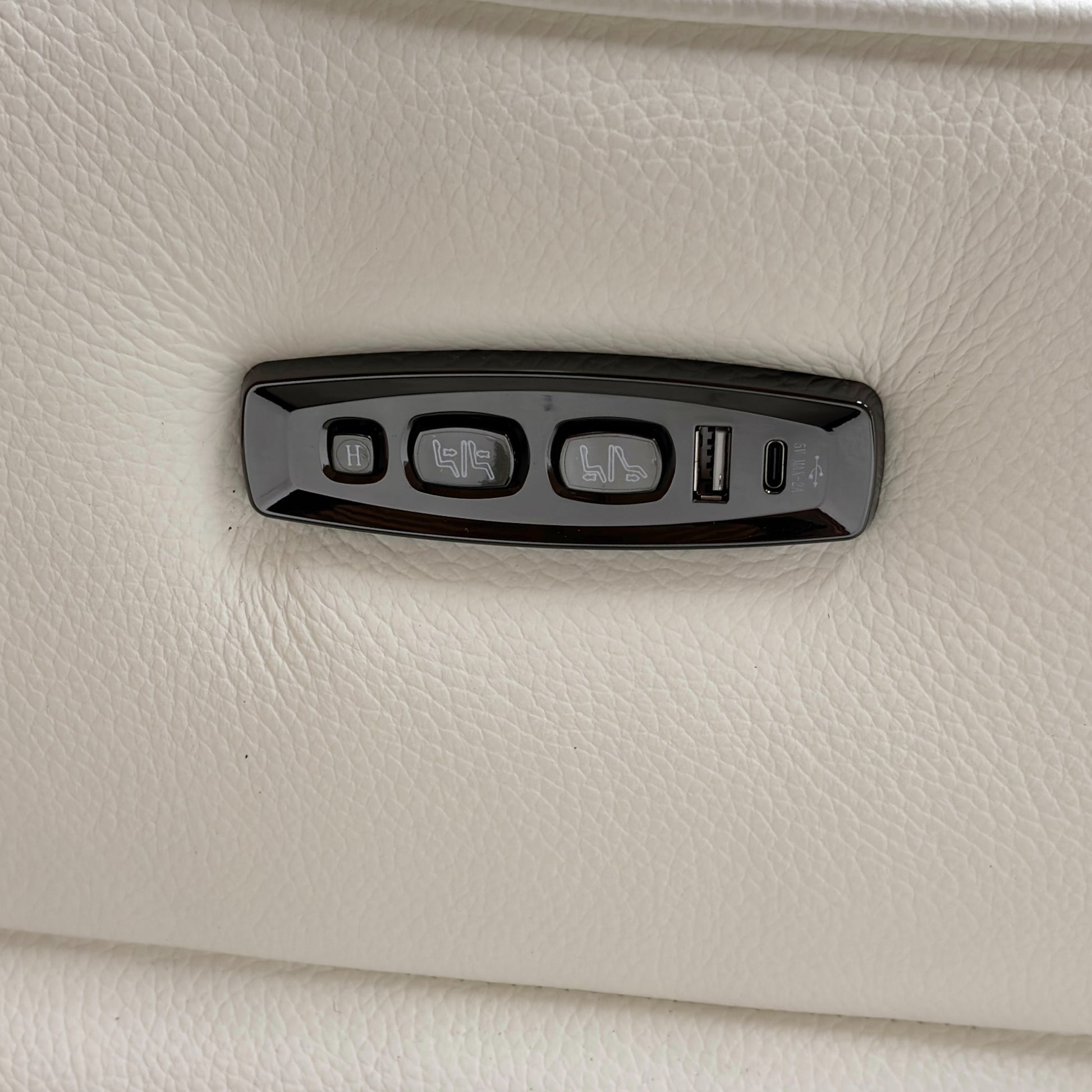 Close-up of the power headrest mechanism in the upright position, demonstrating the high-back support