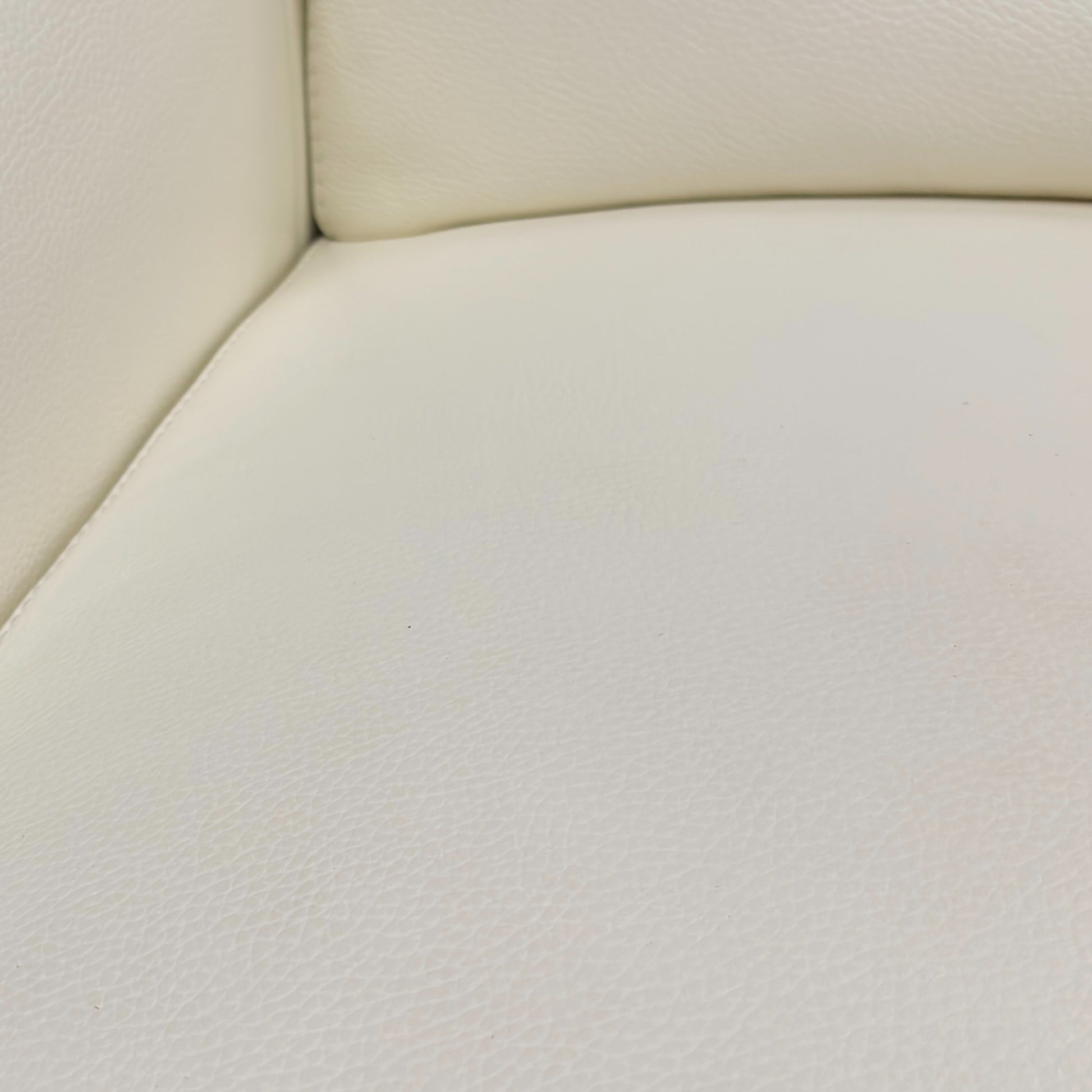 Close-up of the right-hand facing open-end chaise section, focusing on the pristine Star White leather and the integrated control buttons for the power recliner and headrest