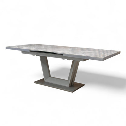 Detail showing the smooth transition and seamless look of the marble-effect ceramic top when the extension leaf is deployed.