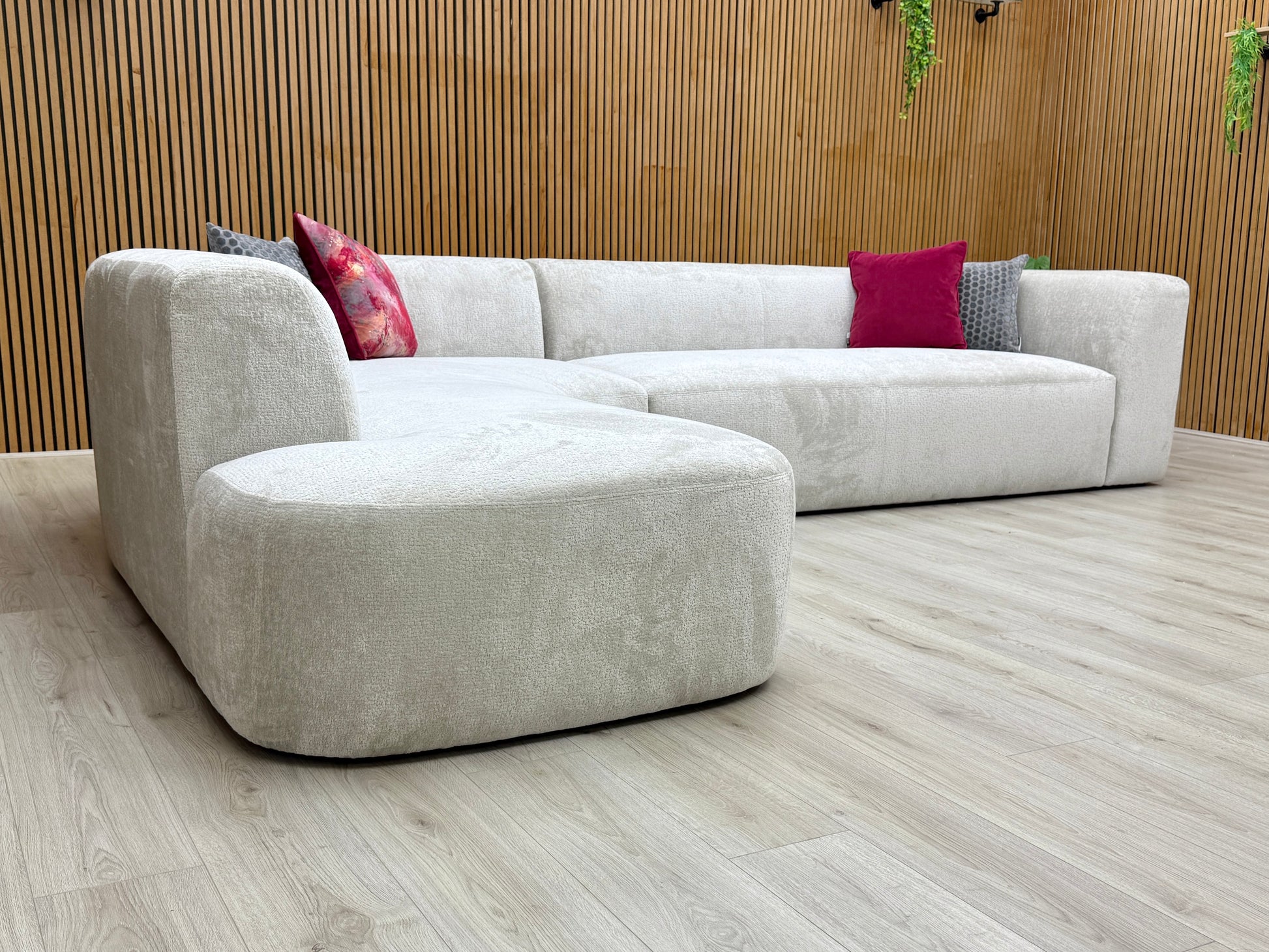 Angled view of the 'Los Angeles' 6-seater corner sofa, highlighting the low profile, deep seating, and open-end left-hand facing chaise in turtledove grey chenille fabric.