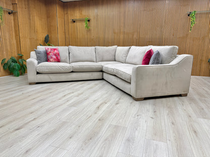 Side view of a section of the 'Isobel' sofa, illustrating the sofa's depth, low profile, and substantial armrests.