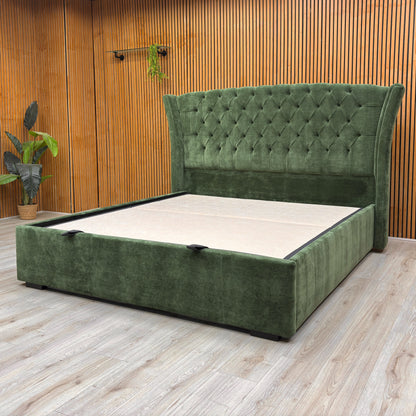 Lifestyle image of the Super King-size 'Dorian' bed in a bedroom, demonstrating its substantial size and the rich color of the moss fabric.