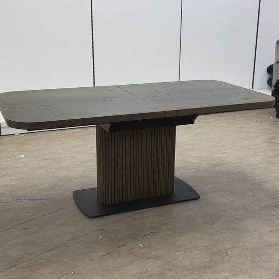 Video demonstration of the Jai dark oak dining table, showcasing the easy-to-use butterfly extension mechanism.