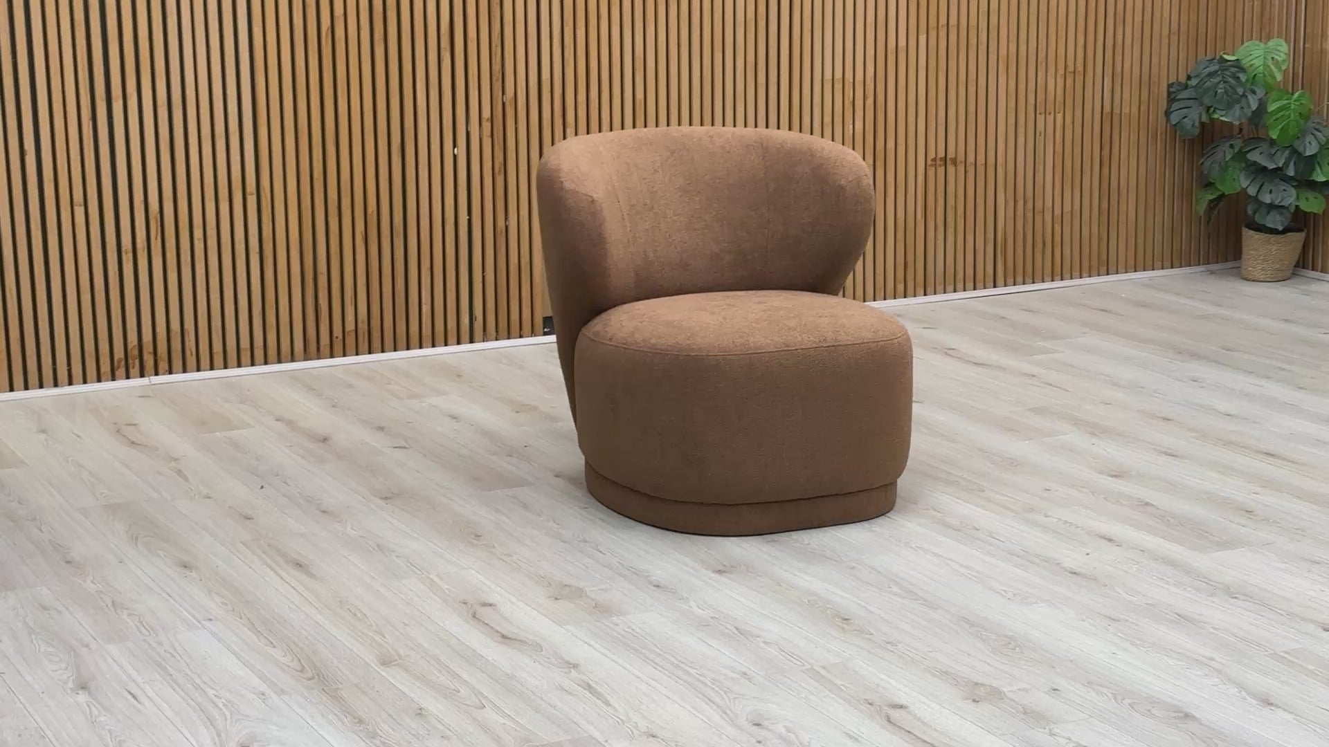 Video demonstration of the Sofology 'Knox' accent chair, showcasing the warm ginger fabric, construction quality, and comfort.