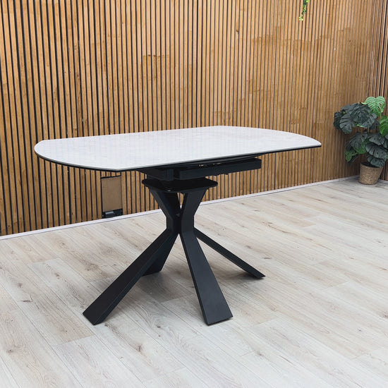 Product demonstration of the Crete Swivel Extending Table, showing the smooth 360-degree rotation of the extension leaves to expand the seating area.