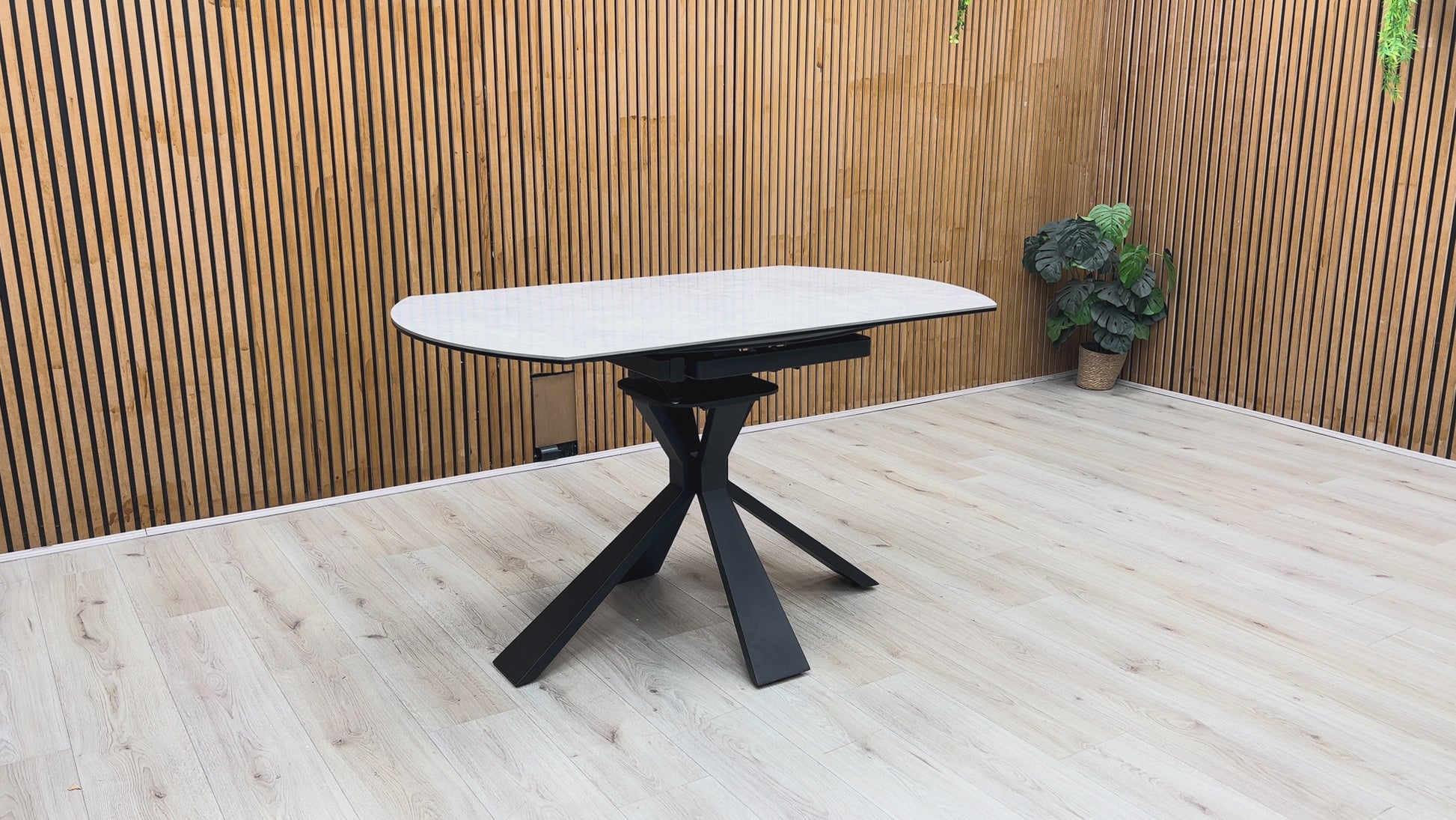 Product demonstration of the Crete Swivel Extending Table, showing the smooth 360-degree rotation of the extension leaves to expand the seating area.
