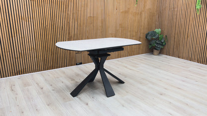 Product demonstration of the Crete Swivel Extending Table, showing the smooth 360-degree rotation of the extension leaves to expand the seating area.