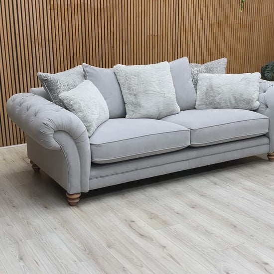 Product video tour of the ‘Blenheim’ Marlborough Silver 4 Seater Sofa, demonstrating the softness of the scatter back cushions and the large-scale lounging space.