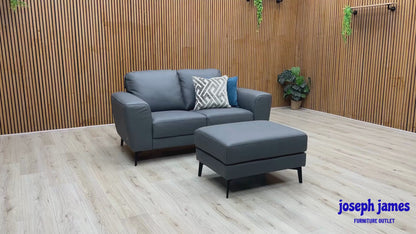 Video Of ‘Bocelli’ contemporary living room suite, showcasing a luxury 2-seater sofa and matching independent footstool beautifully upholstered in Tatto Grey 4370 premium leather.