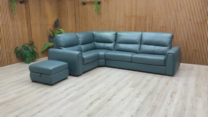A video of Green leather sectional sofa with ottoman on a wooden floor against a wooden wall.