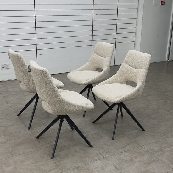 Video of the smooth 360-degree swivel base functionality on the cream boucle dining chair.