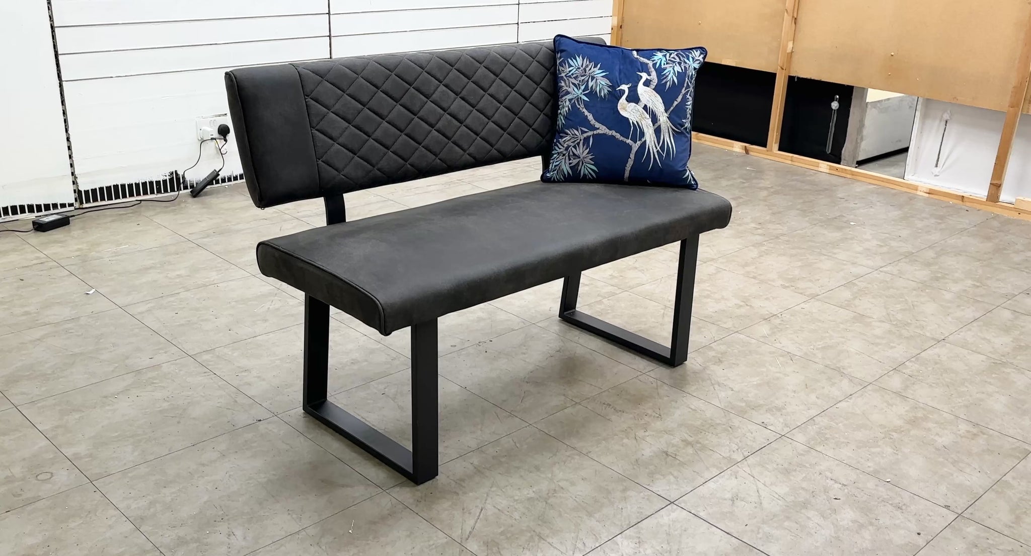 Video demonstration of the 'Warrior' upholstered grey dining bench, showcasing its size, comfort, or quilted stitching detail.