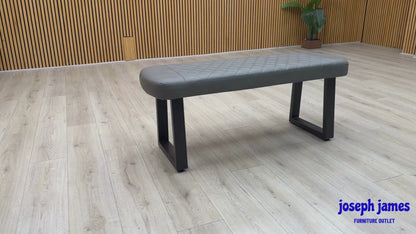 Video Of ‘Venus’ contemporary low dining bench, beautifully upholstered in a durable Grey faux leather with a clean, armless linear profile.