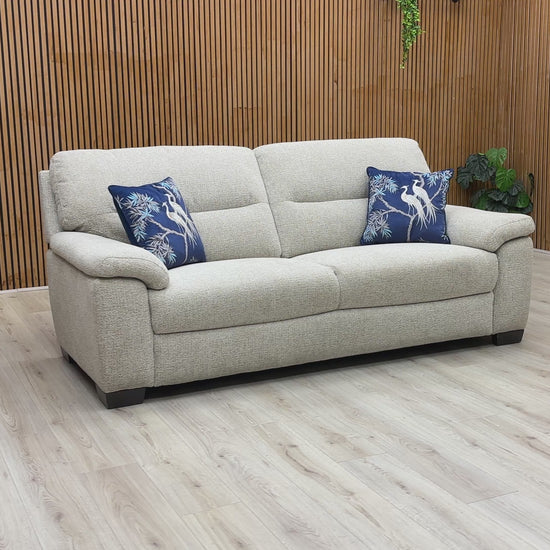 A video of Beige sofa with decorative pillows on a wooden floor and wall background