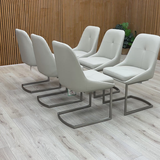 A video of Set of six modern gray chairs on a wooden deck with a wooden wall background