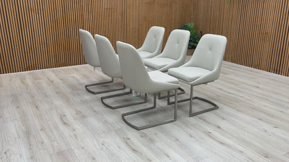 A video of Set of six modern gray chairs on a wooden deck with a wooden wall background