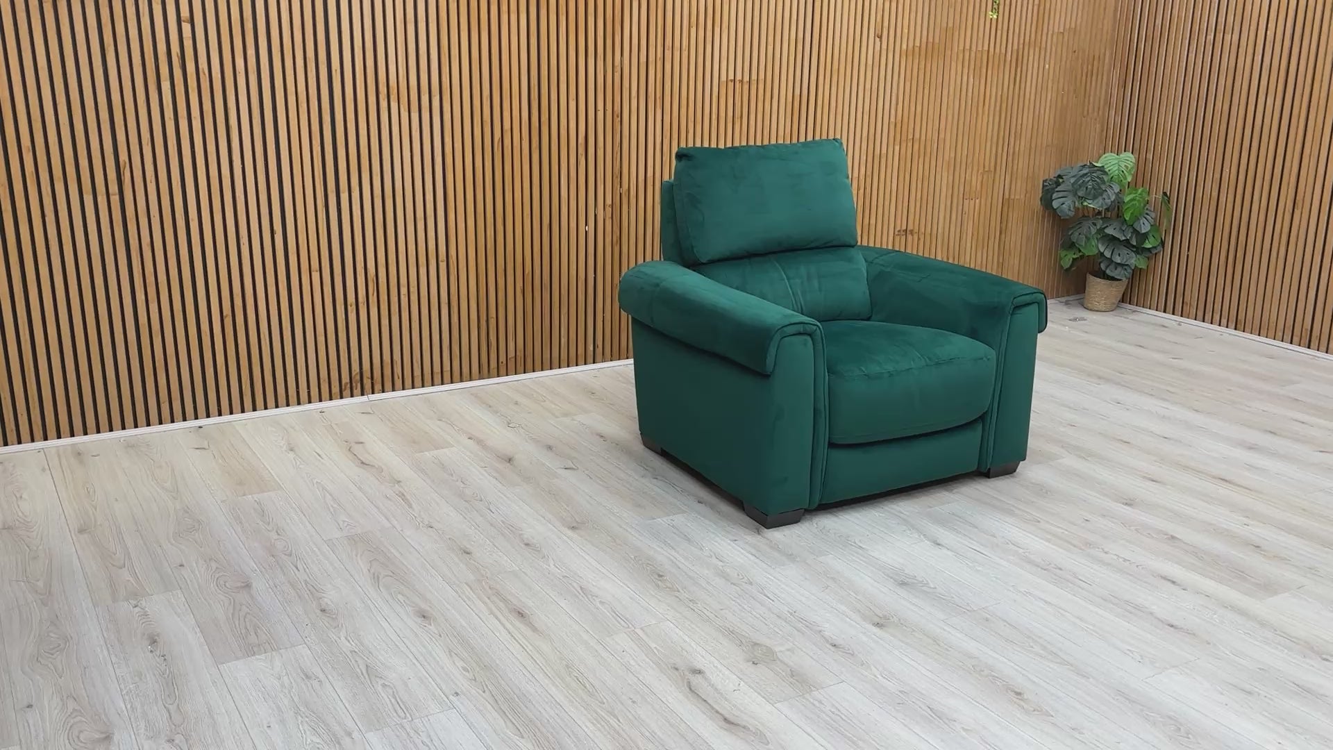 Product video tour of the ‘Nixon’ Emerald Green Velvet Armchair, demonstrating the soft fabric texture, seat comfort, and high-quality construction.