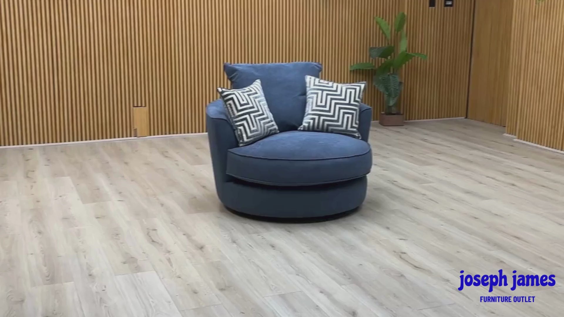 Video of ‘Legend’ contemporary classic-back swivel armchair, beautifully upholstered in high-grade Cosmo Navy Blue fabric, featuring a deep, inviting tub-style silhouette and a hidden rotational base.