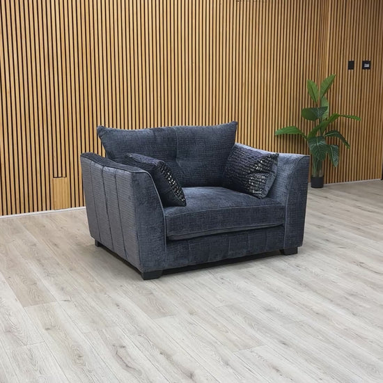 Product video tour of the ‘Allure’ Coco Indigo Snuggler Chair, demonstrating the woven fabric texture, seat cushion bounce-back, and overall sturdiness.