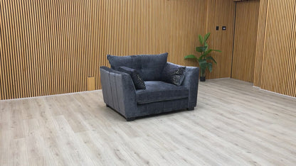 Product video tour of the ‘Allure’ Coco Indigo Snuggler Chair, demonstrating the woven fabric texture, seat cushion bounce-back, and overall sturdiness.