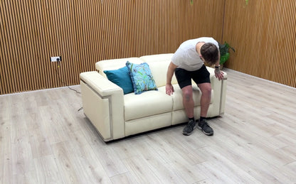 Product demonstration video showing the smooth power reclining mechanism and adjustable power headrests of the 'Cora' white leather sofa.