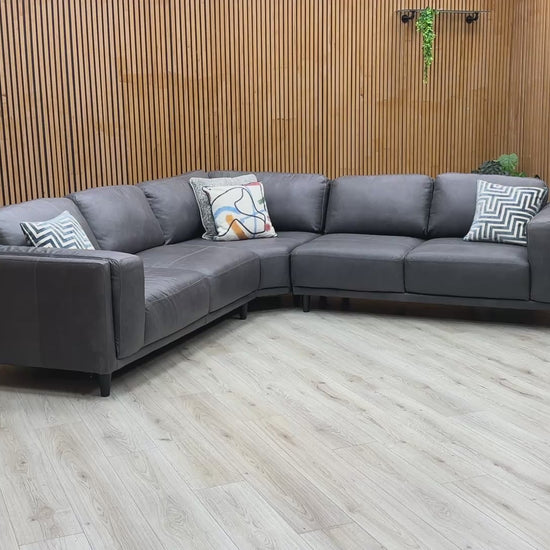 Product tour of the Brody Grey Italian Leather Corner Sofa, demonstrating the leather's quality, seat bounce, and the solid build of the frame.
