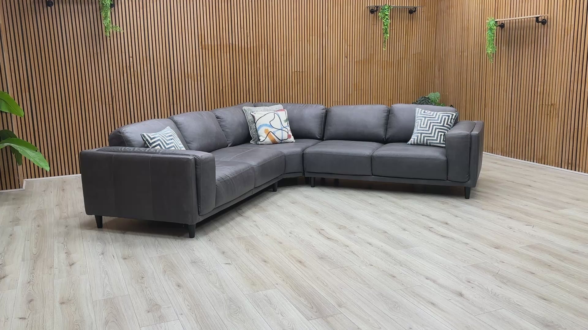 Product tour of the Brody Grey Italian Leather Corner Sofa, demonstrating the leather's quality, seat bounce, and the solid build of the frame.