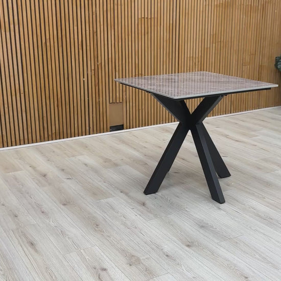 Video demonstration of the 'Kyoto' square table, showing the surface quality and sturdy fixed-frame construction.