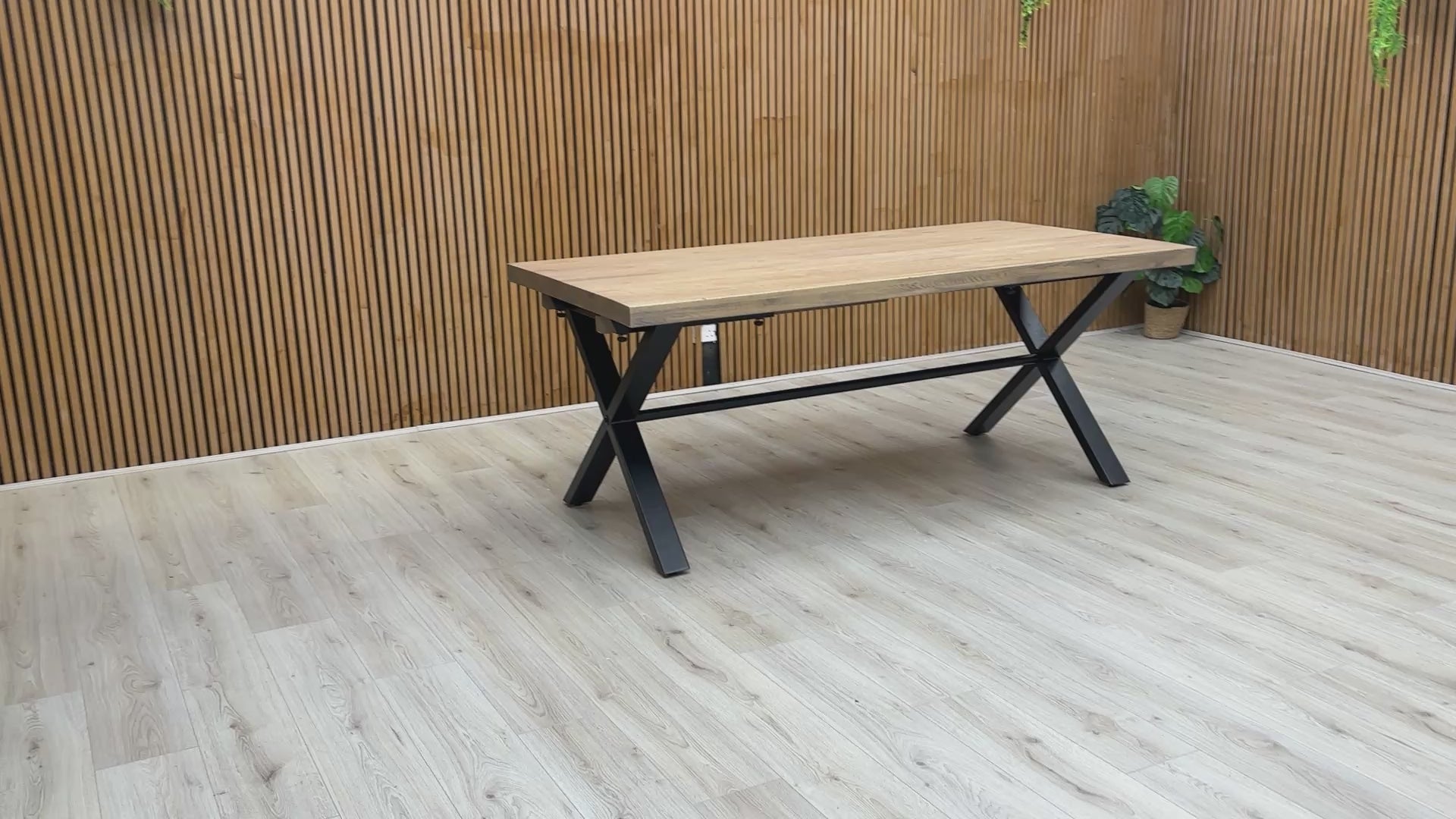 Video preview of the Saturn Solid Oak Dining Table on a black X-shaped base.