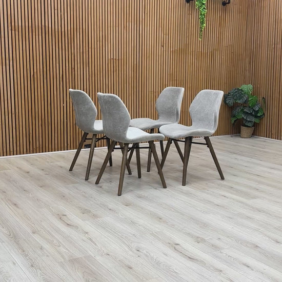 Product video showing the Stockholm dining chair from multiple angles, focusing on the dark oak legs and soft-sheen lacquer finish.