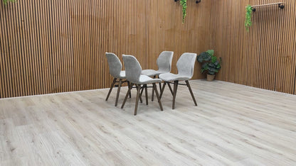 Product video showing the Stockholm dining chair from multiple angles, focusing on the dark oak legs and soft-sheen lacquer finish.