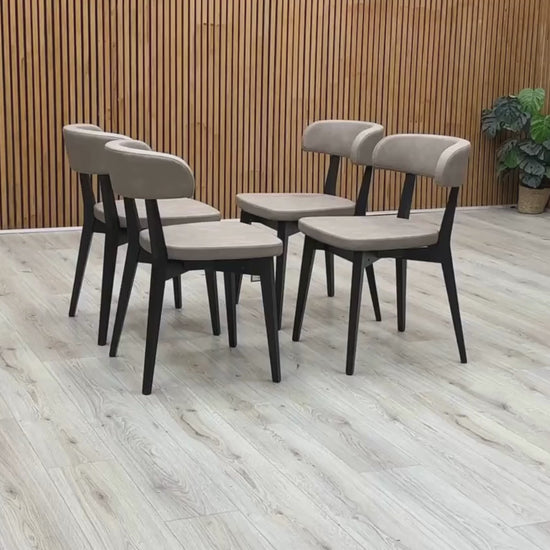 Video Of ‘Connubia Siren S0A’ contemporary dining chairs, showing a matching set of 4 individual chairs featuring a sleek Graphite wooden frame and seats upholstered in Vintage Desert Taupe faux leather.