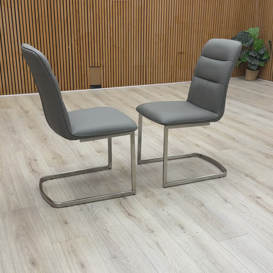 360-degree video showcase of the charcoal cantilever chairs, highlighting the sleek metal frame and cushioned seat.